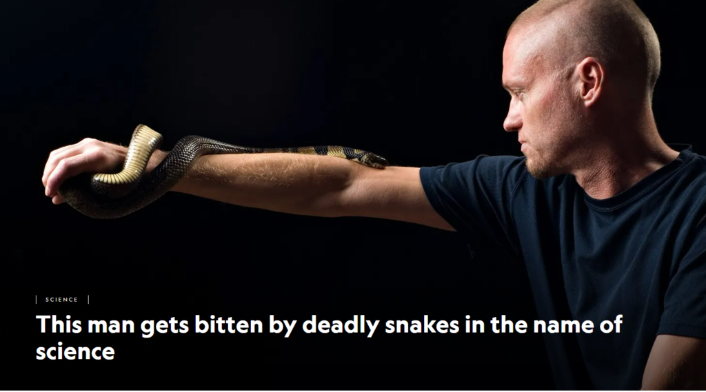 Photo from National Geographic article of a man with a snake wrapped around his arm