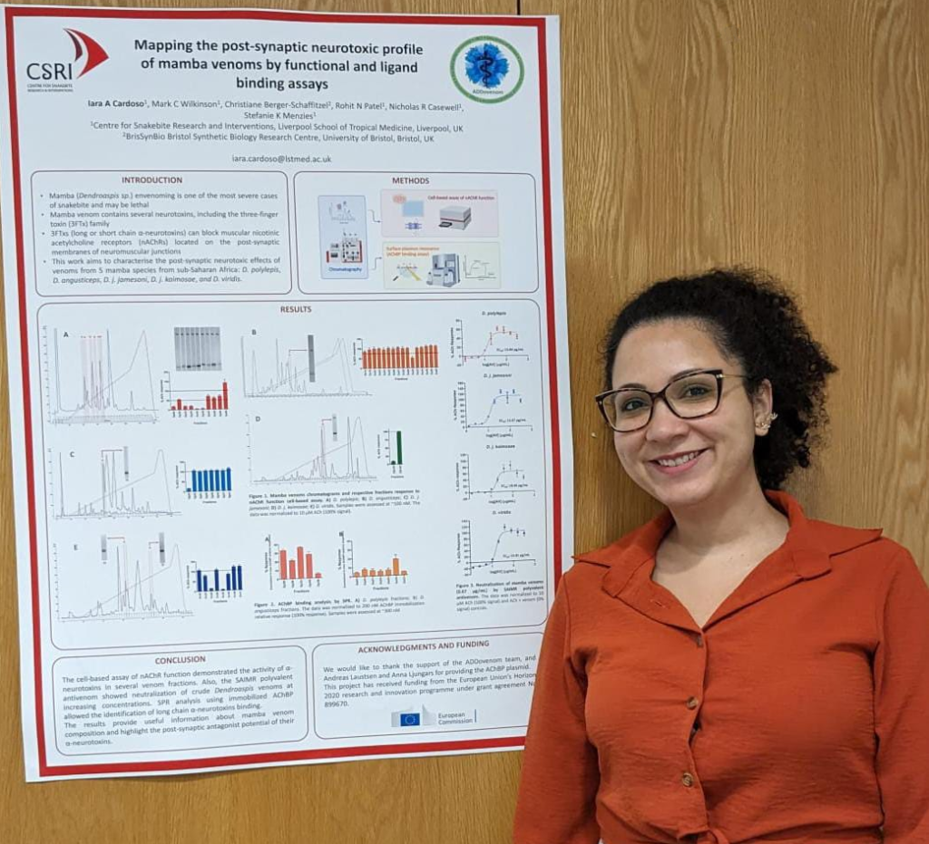Iara Cardoso stands next to her poster.